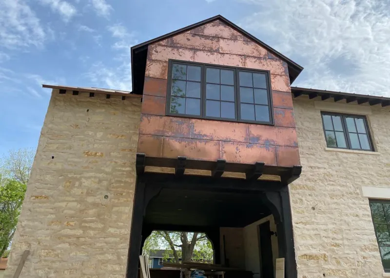 Copper metal panel facade on a stone building for Skylight Installation in McLean